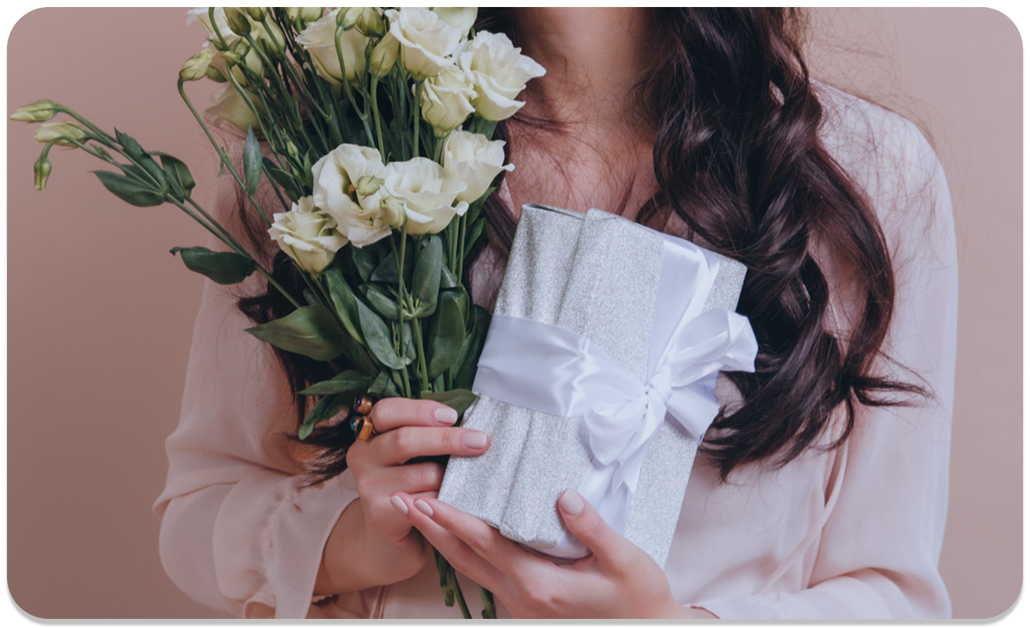Person holding white roses